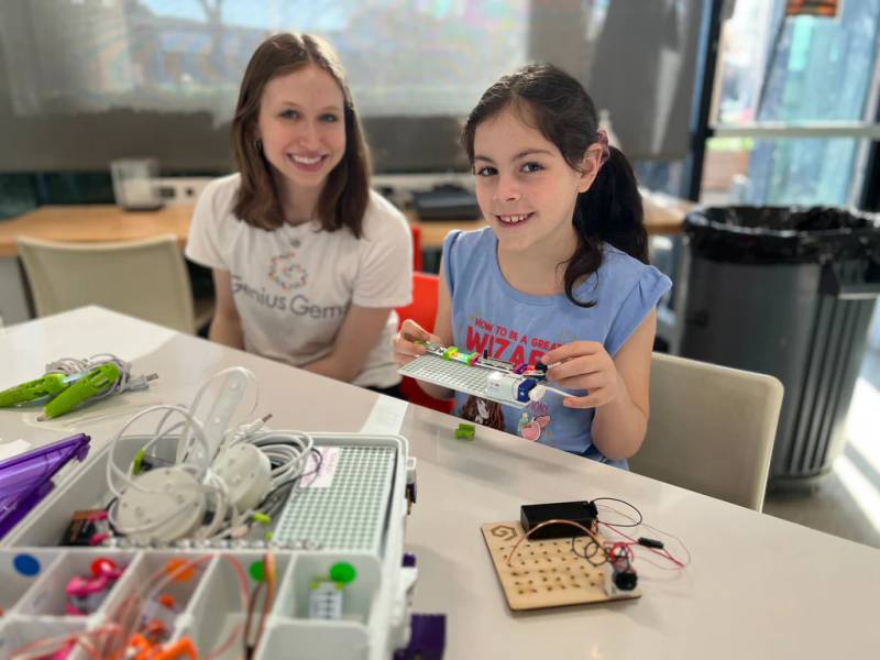 An instructor and a student with an electronics kit at Genius Gems Millburn