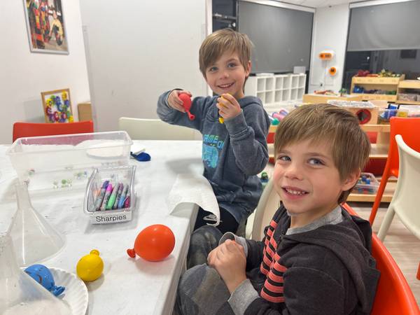 Two boys building an engineering project at a party table
