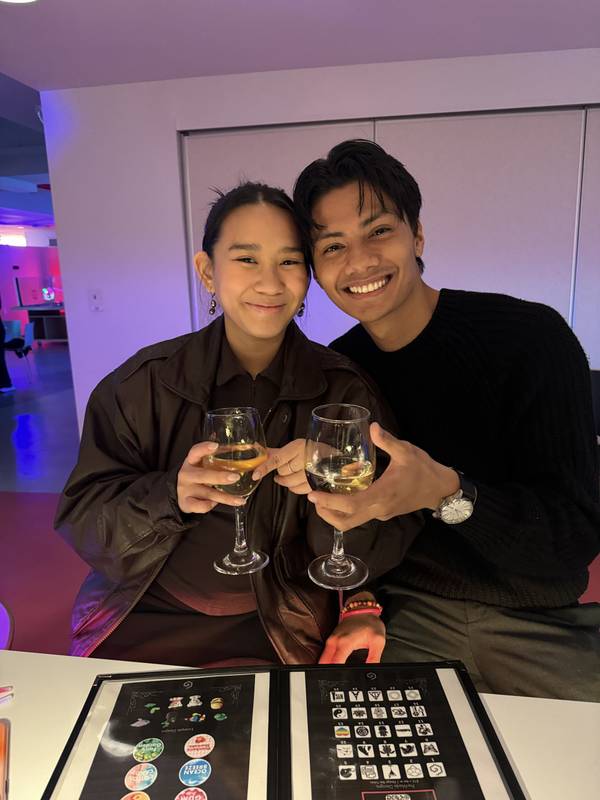 A couple toasting with white wine at the Design Bar