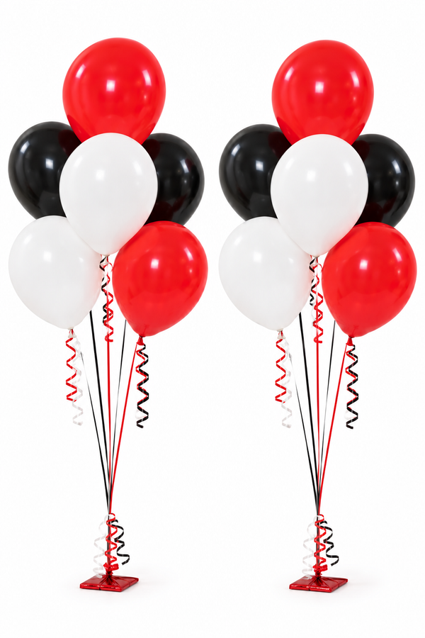 Two balloon bouquets with red, white, and black balloons tied with curled ribbons to red table weights.