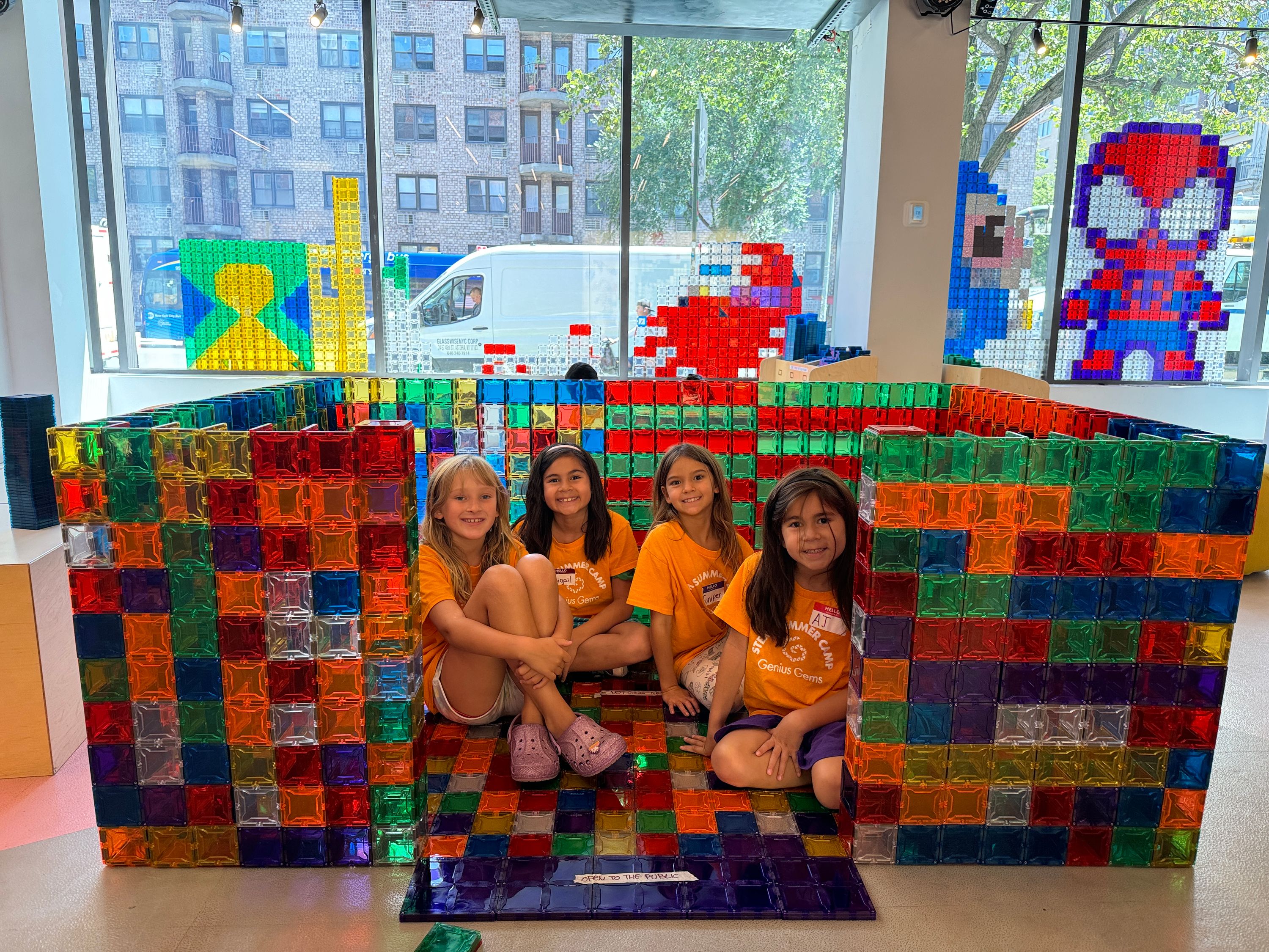 Girls creating massive magnetic-tile structures at Genius Gems NYC