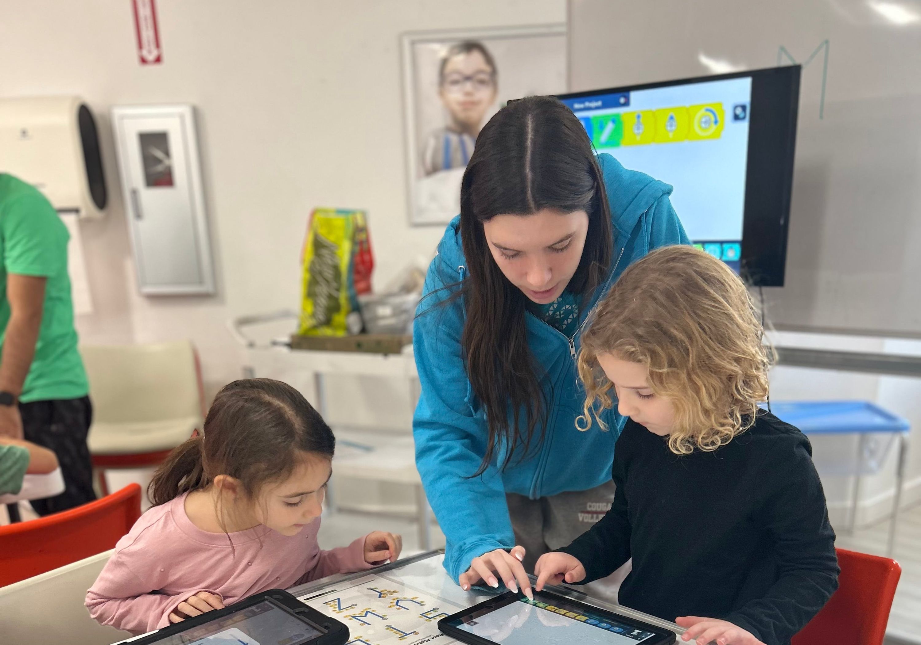 Staff teaching coding to girls at Genius Gems Millburn