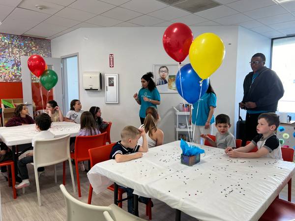 The Millburn party room set with balloons and confetti tables